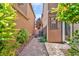 View of the side yard with brick paver walkway and gravel landscaping at 2432 Granada Bluff Ct, Las Vegas, NV 89135