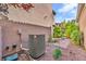 Home's side yard features a gravel bed, paved walkway and large AC unit at 2432 Granada Bluff Ct, Las Vegas, NV 89135