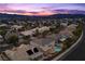 Twilight aerial view of a home with a pool in a neighborhood with city and mountain views at 2647 Hourglass Dr, Henderson, NV 89052