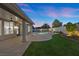 Lovely backyard with covered patio, pool and spa, and manicured lawn perfect for entertaining at 2647 Hourglass Dr, Henderson, NV 89052