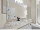 Bright bathroom with granite counters, undermount sink, and large mirror over the vanity at 2647 Hourglass Dr, Henderson, NV 89052