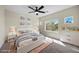 Bright bedroom with large windows for natural light and ceiling fan above the bed and dresser at 2647 Hourglass Dr, Henderson, NV 89052