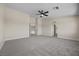 Spacious carpeted bedroom featuring an ensuite bathroom and a ceiling fan at 2647 Hourglass Dr, Henderson, NV 89052