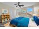 This bright bedroom offers a large window, a ceiling fan and a spacious closet for storage at 2647 Hourglass Dr, Henderson, NV 89052