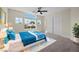 Bright bedroom features a large window, ceiling fan, double closet and plush carpet at 2647 Hourglass Dr, Henderson, NV 89052