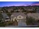 Beautiful two-story home with a three-car garage, professional landscaping, and mountain views at 2647 Hourglass Dr, Henderson, NV 89052