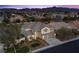 Gorgeous two-story home featuring a three-car garage, neat front yard, and elegant entryway at 2647 Hourglass Dr, Henderson, NV 89052