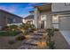Beautiful home featuring stone steps leading to the front door with manicured landscaping at 2647 Hourglass Dr, Henderson, NV 89052
