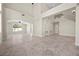 Expansive open floor plan with a staircase, large windows, and tiled floors at 2647 Hourglass Dr, Henderson, NV 89052