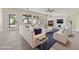 Bright and airy living room with a fireplace, ample seating, and natural light at 2647 Hourglass Dr, Henderson, NV 89052