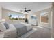 Bright main bedroom features three large windows, neutral paint, and an elegant ceiling fan at 2647 Hourglass Dr, Henderson, NV 89052
