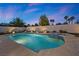 Serene backyard pool and spa area with well-maintained landscaping, illuminated for evening enjoyment at 2647 Hourglass Dr, Henderson, NV 89052