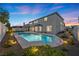 Inviting backyard oasis with a sparkling pool and lush landscaping at 2647 Hourglass Dr, Henderson, NV 89052