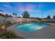 Inviting pool with spa, lush landscaping, and subtle lighting creating a serene evening ambiance at 2647 Hourglass Dr, Henderson, NV 89052