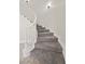 Elegant curved staircase with white banister and plush carpeting for a luxurious feel at 2647 Hourglass Dr, Henderson, NV 89052