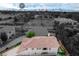 Elevated view of a cozy home and its backyard with the Las Vegas Strip in the background under a partially cloudy sky at 2679 Regency Cove Ct, Las Vegas, NV 89121