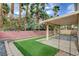 Covered patio overlooking a well-maintained backyard with artificial grass and palm trees at 2679 Regency Cove Ct, Las Vegas, NV 89121