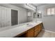 Bright bathroom with a long vanity, double sinks, and large mirror at 2679 Regency Cove Ct, Las Vegas, NV 89121