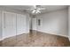 This light-filled bedroom has wood-look floors, a closet with sliding doors, and light gray walls at 2679 Regency Cove Ct, Las Vegas, NV 89121