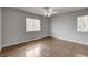 Light-filled bedroom features wood-look floors and a ceiling fan at 2679 Regency Cove Ct, Las Vegas, NV 89121
