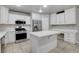 Well-equipped kitchen with stainless steel appliances, island, and integrated desk area at 2679 Regency Cove Ct, Las Vegas, NV 89121