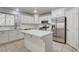 Bright kitchen with stainless steel appliances, white cabinets and a center island at 2679 Regency Cove Ct, Las Vegas, NV 89121