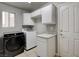This laundry room features modern washer and dryer at 2679 Regency Cove Ct, Las Vegas, NV 89121