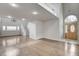 Bright, open-concept living room featuring hardwood floors, natural light, a staircase, and an elegant front entrance at 2679 Regency Cove Ct, Las Vegas, NV 89121