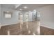 Spacious living area boasts neutral colors, hardwood floors, and seamless flow to kitchen and dining through archways at 2679 Regency Cove Ct, Las Vegas, NV 89121