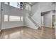 Bright open living area features a staircase and chandelier for a modern touch at 2679 Regency Cove Ct, Las Vegas, NV 89121