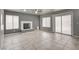 Inviting living room features neutral tile flooring, a modern fireplace, and a sliding glass door for ample natural light at 2679 Regency Cove Ct, Las Vegas, NV 89121
