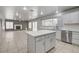 Open-concept living and kitchen area, featuring a fireplace and modern appliances at 2679 Regency Cove Ct, Las Vegas, NV 89121