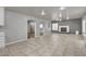 Spacious living room with neutral decor, tile floors, and an archway leading to other rooms, perfect for entertaining at 2679 Regency Cove Ct, Las Vegas, NV 89121