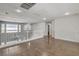 Open loft area with hardwood floors, chandelier, and natural light creates a versatile space at 2679 Regency Cove Ct, Las Vegas, NV 89121
