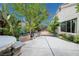 Lush backyard featuring mature trees, beautiful landscaping, and an ornate garden fountain feature at 2837 Du Barry Manor Ln, Las Vegas, NV 89108