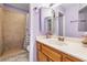 Well-lit bathroom featuring updated fixtures, and a walk-in shower with decorative tile and purple paint at 2837 Du Barry Manor Ln, Las Vegas, NV 89108