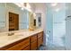 Bright bathroom featuring a double vanity, neutral countertops, and updated fixtures and walk-in closet at 2837 Du Barry Manor Ln, Las Vegas, NV 89108