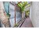 Side yard walkway featuring plants, flowers, rock landscaping, and a lattice-covered section at 2837 Du Barry Manor Ln, Las Vegas, NV 89108