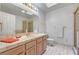 Bathroom featuring a large vanity with a sink, shower behind glass, and tile flooring at 2851 S Valley View Blvd # 1196, Las Vegas, NV 89102