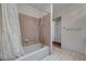 Bathroom with a shower-tub combination featuring beige tile surround, a shower curtain, and tile flooring at 2851 S Valley View Blvd # 1196, Las Vegas, NV 89102