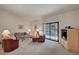 Comfortable living room with neutral carpet, sliding glass doors, and ample seating at 2851 S Valley View Blvd # 1196, Las Vegas, NV 89102