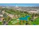 Stunning aerial view of a golf course community with lush greenery, serene ponds, and city skyline at 2989 Bel Air Dr, Las Vegas, NV 89109