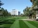 View of a meticulously manicured golf course with towering buildings in the background at 2989 Bel Air Dr, Las Vegas, NV 89109