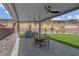 Inviting backyard featuring a covered patio, ceiling fans, built-in grill, dining area, and well-maintained landscaping at 313 Forsyth Park St, Las Vegas, NV 89138