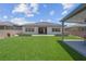 A spacious backyard features artificial turf, a gazebo, and an outdoor living area with landscaping at 313 Forsyth Park St, Las Vegas, NV 89138