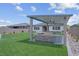A spacious backyard features artificial turf, a gazebo, and an outdoor kitchen with landscaping at 313 Forsyth Park St, Las Vegas, NV 89138