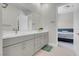 Bright bathroom features double sinks, gray cabinets, and a view to the main bedroom at 313 Forsyth Park St, Las Vegas, NV 89138