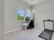 Bright bedroom features a work desk, lots of natural light, and a treadmill for exercising at 313 Forsyth Park St, Las Vegas, NV 89138