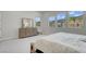 Well-lit bedroom with multiple windows showcasing the outdoor scenery and a classic wooden dresser at 313 Forsyth Park St, Las Vegas, NV 89138