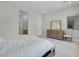Bright bedroom featuring a comfortable bed, neutral colors, and a wooden dresser with a mirror at 313 Forsyth Park St, Las Vegas, NV 89138